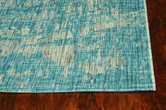 a blue and white rug on top of a wooden floor next to a wood floor