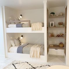 two bunk beds in a room with white walls and carpeted flooring on the other side