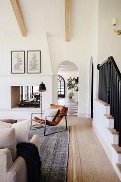 a living room filled with furniture and a fire place in the middle of a hallway