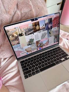 an open laptop computer sitting on top of a pink blanket next to a stuffed animal