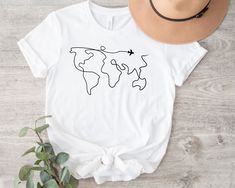 Travel Shirt, Adventure Shirt, World Map Travel Shirt, Unisex Shirt, Road Trip Shirt, Traveler Gift, Wanderlust Shirt  ORDER INSTRUCTIONS  ➤ Check and review all listing photos. ➤ Pick up your item's size and color from drop down menus. ➤ Choose the quantity. ➤ Click "Add to Cart" button. ➤ Fill in the personalization box as recommended if provided.  ➤ You can go back to add more item or you can complete the checkout process. ➤ Click "Proceed to Check Out".  WHICH SIZE FITS ME BEST  ➤ In each li White Cotton Top For Travel, White Crew Neck T-shirt For Travel, White Graphic Print Top For Travel, Travel Shirts Ideas, Travel T Shirts, World Map Travel, Heat Press Printing, Map Travel, Travel Shirt