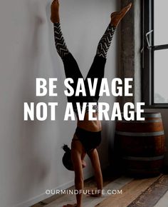 a woman doing a handstand in front of a window with the words be savage not average