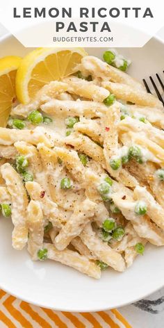 lemon ricotta pasta with peas on a white plate