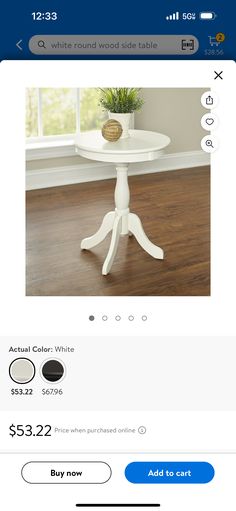 a white table sitting on top of a wooden floor