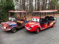 two cars with faces painted on them are parked next to each other