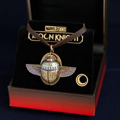 Product Details Officially Licensed by Marvel Artisan brass, enamel Articulated wings held to removable back with magnets 5mm thick leather cord, adjustable slide knot up to 28 inches 34mm x 25mm x 10mm (not including bail) Product Features Created in collaboration with Marvel Studios and inspired by the actual Scarab Compass seen in Marvel Studios’ Moon Knight. Handcrafted in durable artisan brass with a distressed finish offset by blackened details, the Moon Knight Scarab Compass accurately re The Moon Knight, Articulated Wings, Beetle Wings, Marvel Moon Knight, Egyptian Design, Compass Pendant, Marvel X, Moon Knight, Marvel Studios