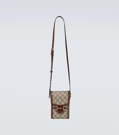 A miniature style with a rectangular silhouette, this strapped shoulder bag from Gucci is crafted from GG canvas elevated with smooth, brown leather trims. At the front, the label's iconic gold-tone Horsebit emblem completes the design..Color of fastening: gold.Made in Italy.Designer color name: B.Eb/Brownsugar.Comes with dust bag.Material: calf leather.Internal details: suede lining.Adjustable shoulder strap.Height 17cm-6.5'.Width 11cm-4.5'.Depth 5cm-2'.Min. length shoulder strap 90cm-35.5'.Max Gucci Rectangular Shoulder Bag With Adjustable Strap, Vintage Gucci Rectangular Shoulder Bag, Vintage Gucci Coated Canvas Shoulder Bag, Gucci Rectangular Shoulder Bag With Leather Trim, Gucci Brown Shoulder Bag With Leather Trim, Gucci Brown Shoulder Bag With Adjustable Strap, Brown Gucci Shoulder Bag With Adjustable Strap, Vintage Brown Bag With Horsebit Detail, Beige Rectangular Shoulder Bag With Horsebit Detail