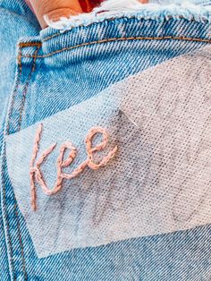 someone's jeans with the word keep written on them, and their hand in the pocket