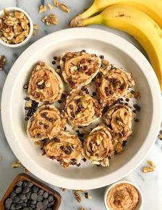 a white bowl filled with cookies next to bananas