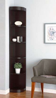 a corner shelf in the corner of a room with a chair and potted plant