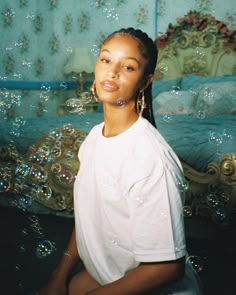 a woman sitting on the floor in front of bubbles