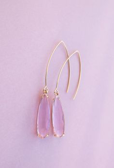 Pink Pendant Earrings ⟡ all items are designed and handcrafted in our studio ⟡ Long pink glass and gold teardrop earrings. These drool-worthy teardrop earrings boast a dreamy pink glass stone set in a glamorous gold-plated brass setting, making any outfit look luxe in an instant. The long wire creates a dramatic yet effortless look that you can wear anywhere. Don't let this must-have accessory slip away!OVERVIEW-3" in length-glass crystals-gold plated over stainless steel ear wiresLooking for mo Pink Long Drop Earrings For Party, Glamorous Teardrop Crystal Earrings For Gift, Pink 14k Gold Filled Dangle Jewelry, 14k Gold Filled Elegant Teardrop Earrings, Elegant 14k Gold-filled Teardrop Earrings, Handmade Pink Drop Jewelry, Chic Teardrop Jewelry Gift, Pink Briolette Earrings For Pierced Ears, Feminine Yellow Gold Earrings For Party