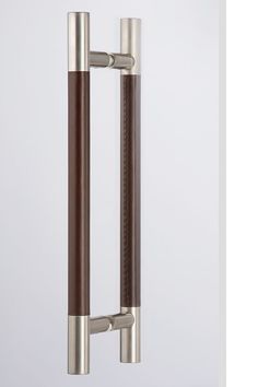 an image of a door handle that is red and stainless steel with brown leather trim