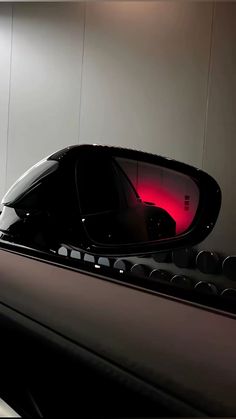 a car's rear view mirror is lit up with red light