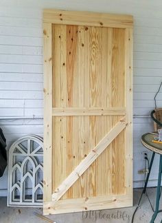 a wooden door sitting on the side of a building