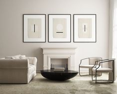 a living room filled with furniture and art on the wall above a white fire place