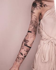 a woman with tattoos on her arm and hand