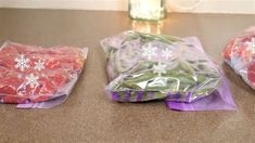 three bags filled with food sitting on top of a counter next to a cup and vase