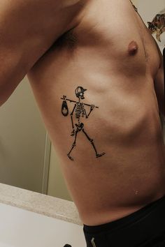 a man with a skeleton tattoo on his stomach