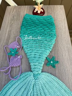 a crocheted mermaid tail is shown on a table