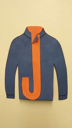 an orange and blue shirt with the letter j on it's collar is cut out