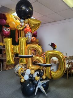 an assortment of balloons in the shape of letters and numbers are arranged on top of each other