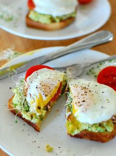 open faced smoked salmon sandwiches with avocado, tomato and mayonnaise on them