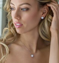 a woman wearing a diamond necklace and earrings