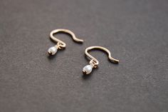 14k gold filled / sterling silver wire and freshwater pearls drop earrings. Just twist them slightly to the back for a tiny hoop look. g o l d . f i l l Gold-fill is an actual layer of gold bonded with pressure to another metal, usually brass or copper. Gold-fill is not to be confused with gold plating as gold-fill has a much thicker layer of gold. Gold filled jewelry does not flake off or rub off and with proper care it can last a lifetime. s t e r l i n g . s i l v e r Sterling silver is an al Dainty Wire Wrapped Pearl Earrings In 14k Gold, Dainty Wire Wrapped 14k Gold Filled Pearl Earrings, Dainty Rose Gold Pearl Earrings 14k Gold Filled, Dainty Rose Gold 14k Gold-filled Pearl Earrings, Dainty 14k Gold Filled Pearl Earrings, Dainty 14k Gold Pearl Earrings, Earrings Gold Pearl, Small Pearl Earrings, Pearl Earrings Gold