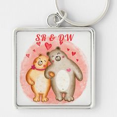 two bears are hugging each other on a square keychain that says sr e q w