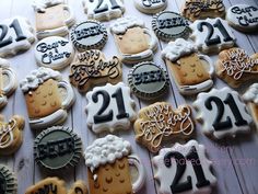 decorated cookies are arranged on a table with the numbers twenty two and twenty four in them