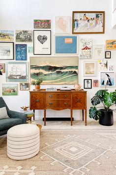 a living room filled with furniture and lots of pictures on the wall above it's coffee table