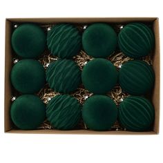 twelve green macaroni and cheese balls in a cardboard box