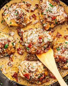 meatballs covered in sauce and garnished with parsley on a skillet