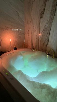 an indoor hot tub lit up with candles