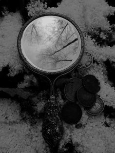 a mirror sitting on top of snow covered ground