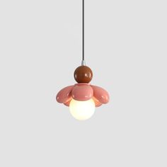 a pink and brown light hanging from a ceiling