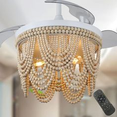 a chandelier made out of beads with a remote control