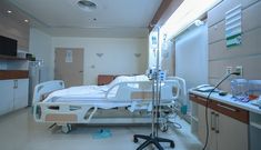 an empty hospital room with medical equipment on the floor