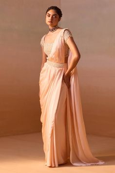 Peach satin pre-draped saree with pearl tassel embellishment on the shoulder. Paired with a cap sleeves floral resham-sequin embroidered blouse. - Aza Fashions Festive Satin Pre-draped Saree In Traditional Shape, Designer Wear Satin Saree With Traditional Drape, Art Silk Pre-draped Saree For Navratri Evening, Evening Art Silk Pre-draped Saree For Navratri, Elegant Satin Choli With Traditional Drape, Embellished Raw Silk Saree With Traditional Drape, Pre-draped Floor-length Saree With Zari Work, Elegant Art Silk Pre-draped Saree In Traditional Drape, Satin Pre-draped Saree With Pallu For Reception