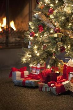 a christmas tree with presents under it