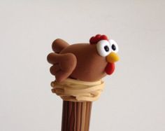 a toy bird sitting on top of a wooden pole with its head sticking out of it's end