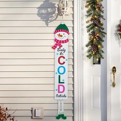 a christmas decoration on the front door of a house with holiday decorations and wreaths