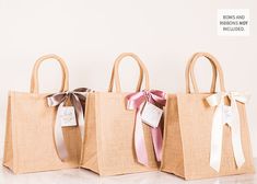 three bags with bows are lined up on the counter top, one has a tag in it