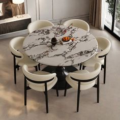 a dining room table with white chairs and a marble topped round table in front of a large window