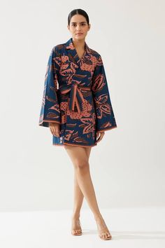 Blue kimono sleeves lapel collar wrap style jacket with all over flowery print. - Aza Fashions Fitted Floral Print Kimono For Spring, Spring Floral Print Fitted Kimono, Fitted Floral Print Spring Robe, Fitted Floral Print Robe For Spring, Spring Floral Print Fitted Robe, Blue Long Sleeve Kimono With Floral Print, Blue Floral Print Long Sleeve Kimono, Fitted Long Sleeve Floral Print Robe, Blue Floral Print Kimono For Fall