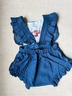 Indulge your little one in style with our handembroidered baby & toddler romper featuring adorable details of a football, tiger, and football shaker delicately stitched onto it. This charming romper is not just a playful addition to your baby's wardrobe but also a nod to the spirit of football season. Made with attention to detail, each stitch brings a touch of artistry to your little champ's outfit. Designed for convenience, this romper has 2 buttons at the top & 3 snaps at the bottom. It can be easily machine washed, ensuring that your child looks cute and stylish without the worry of delicate care instructions. Elevate your child's fashion game and let them stand out in this delightful hand-embroidered romper. Fitted Cotton Bubble Romper For Playdate, Cute Embroidered Cotton Bubble Romper, Football Season Outfits, Overalls Baby Girl, Embroidered Romper, Cotton Overalls, Boy Toddler, Toddler Romper, Girls Clothing Sets