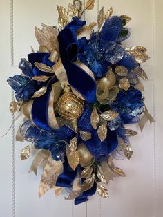 a blue and gold wreath hanging on the wall