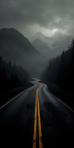 an empty road in the middle of nowhere with mountains in the background and dark clouds