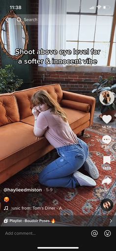 a woman sitting on the floor next to a couch in front of a window with text above it